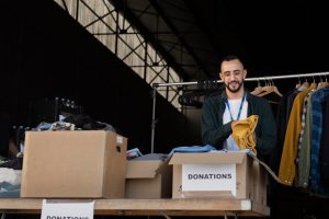 close-up-volunteer-oganizing-stuff-donation_23-2149134446